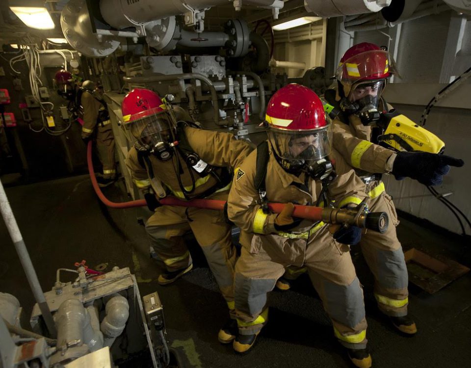 120114-N-DR144-704  ARABIAN SEA (Jan. 14, 2012) Hull Maintenance Technician 3rd Class Oscar Williams, left, Hull Maintenance Technician Fireman Matthew Colon, and Damage Controlman Fireman Donovan Jopling, lead a hose team as they combat a simulated fire in an aircraft elevator machinery room during a general quarters drill aboard the Nimitz-class aircraft carrier USS Carl Vinson (CVN 70). Carl Vinson and Carrier Air Wing (CVW) 17 are deployed to the U.S. 5th Fleet area of responsibility. (U.S. Navy photo by Mass Communication Specialist 2nd Class James R. Evans/Released)